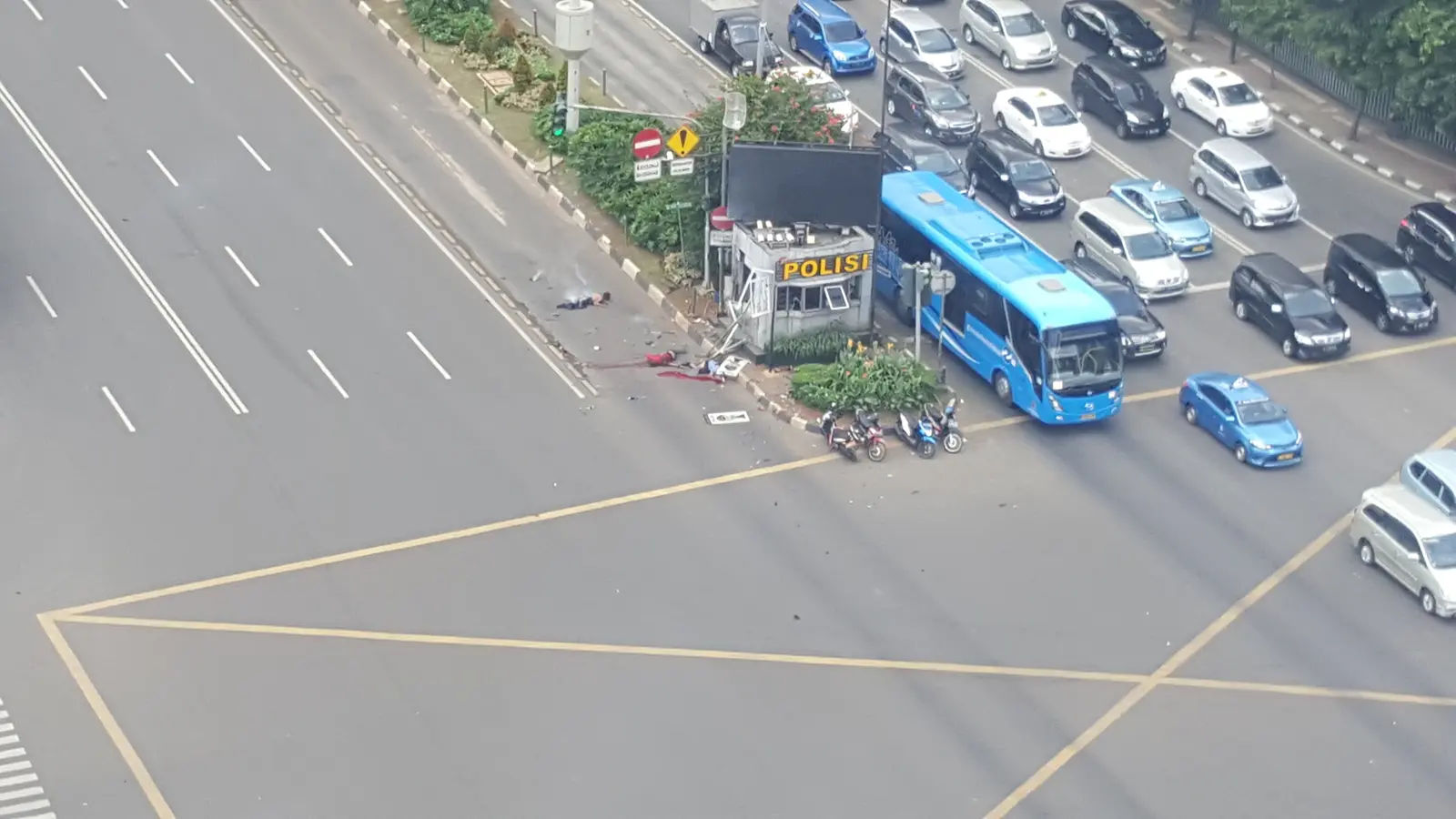 The wrecked traffic police post at the Sarinah intersection, minutes after the bombing